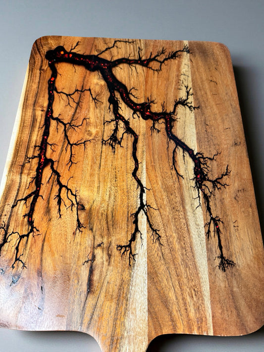 Australian timber paddle board featuring bold red flash resin inlay and electric burn details