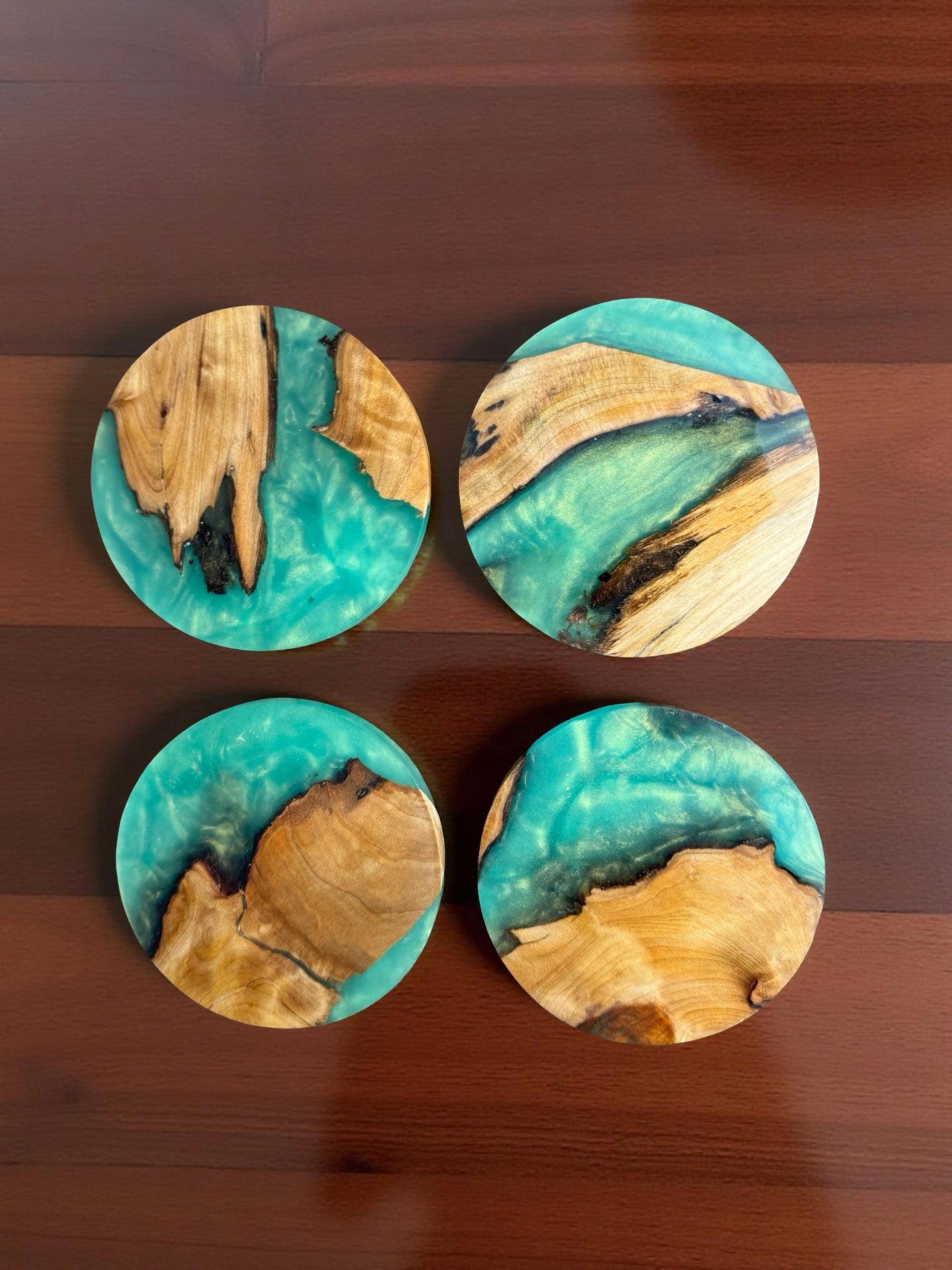 Round green resin coaster crafted from sustainable Australian timber