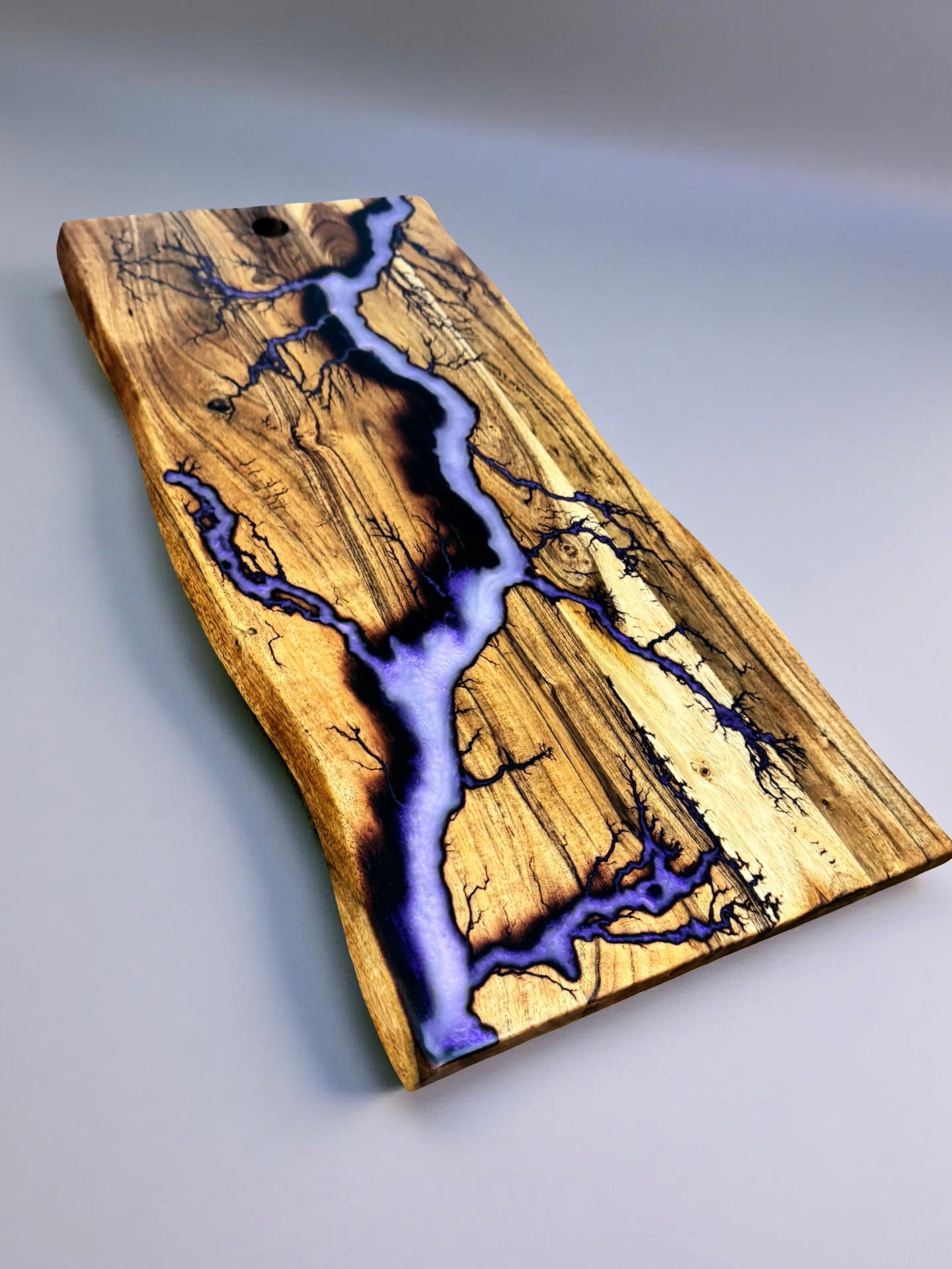 Iridescent purple live edge serving board with lightning bolt burn pattern, handcrafted Australian timber