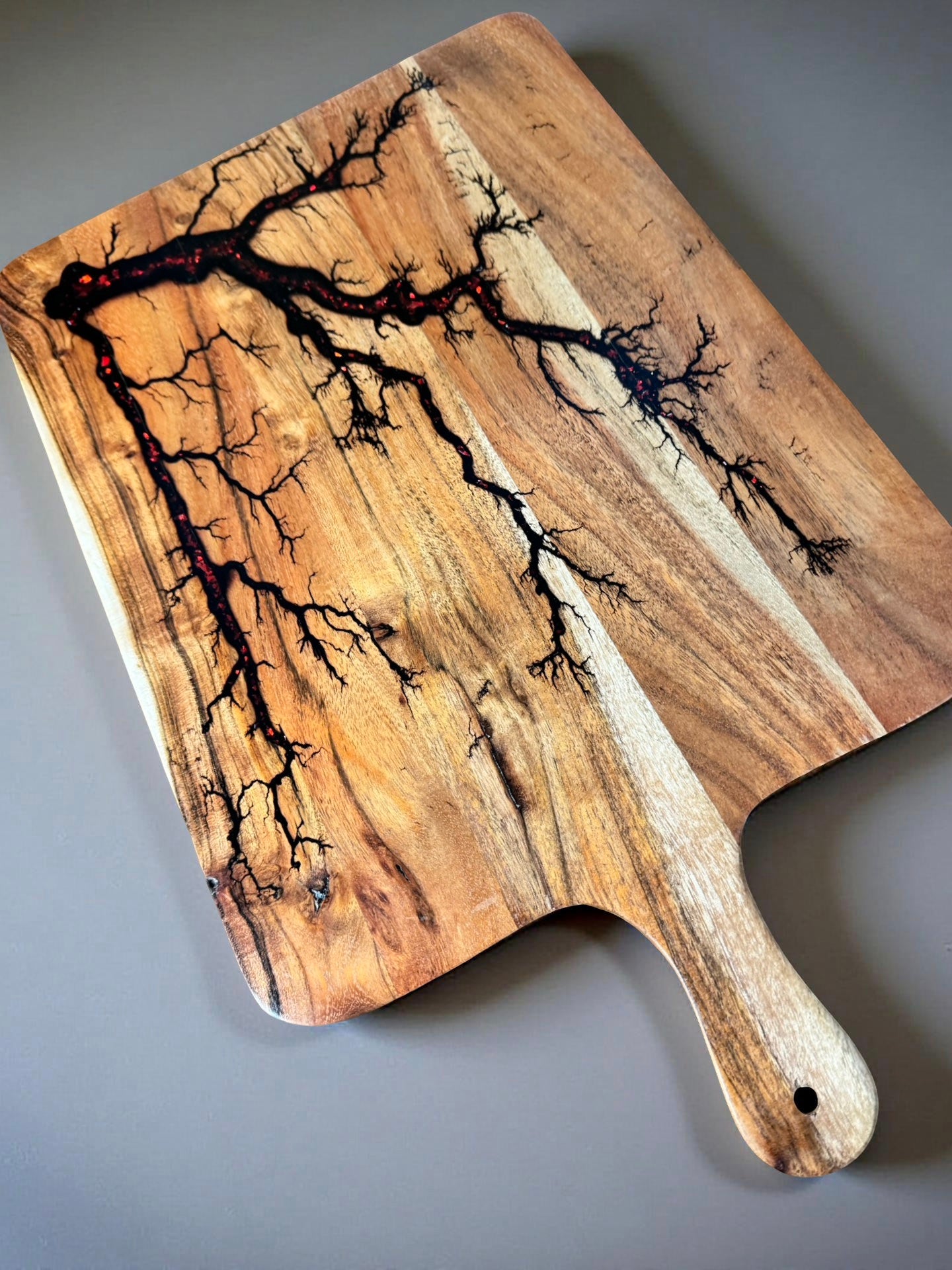 Red flash resin cheese paddle board designed for modern entertaining and crafted in East Gippsland