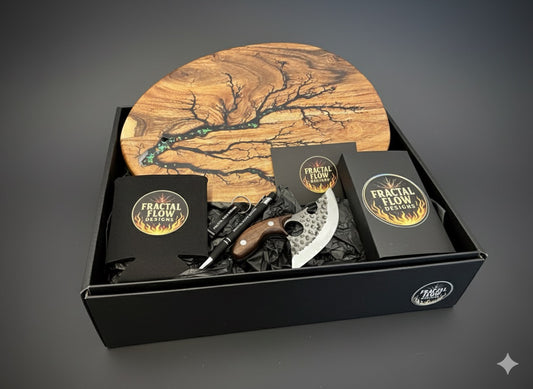 Cheese Lovers Gift Box by Fractal Flow Designs – handcrafted Australian resin board, premium forged cheese knife, fractal burnt timber coasters, and care kit. Made in Bairnsdale, Victoria, ideal for weddings, birthdays, and housewarming gifts.