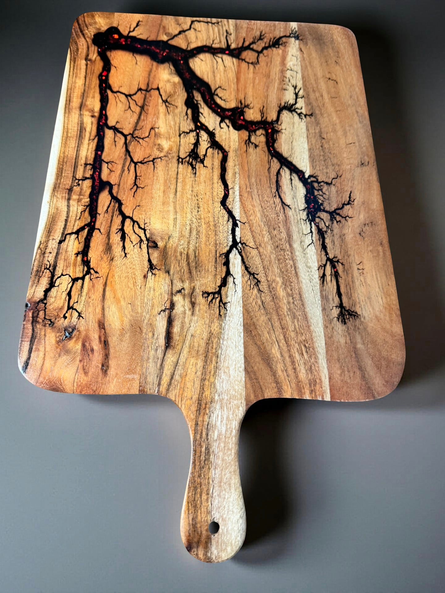 Elegant paddle board with shimmering red flash resin artwork and fractal burning from Fractal Flow Designs