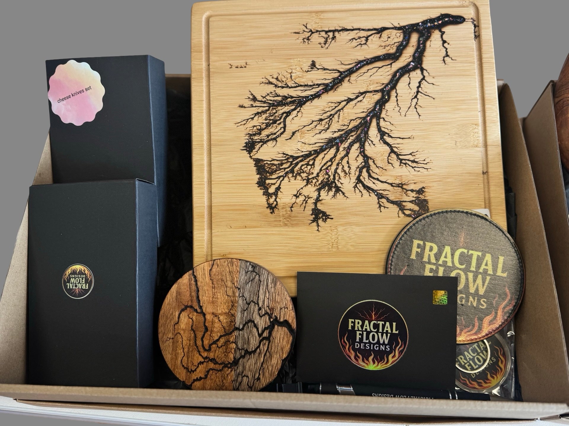 Cheese Lovers resin board gift box from Bairnsdale Victoria with handcrafted platter, knife, coasters, and opener, premium Australian-made present for special occasions.