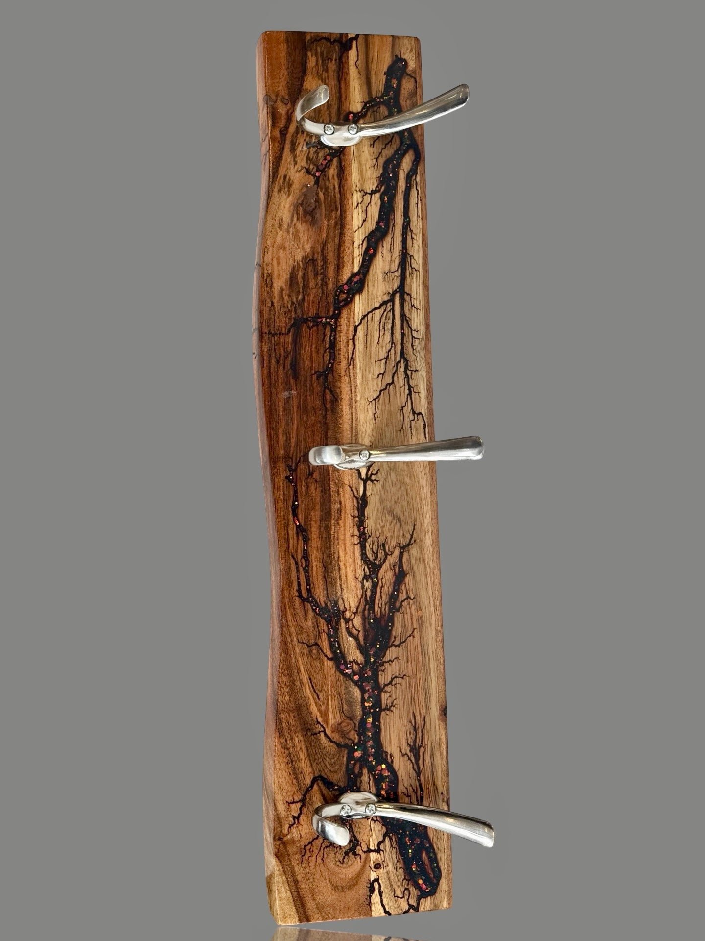 made in Australia is this wall rack by Fractal Flow Designs featuring fractal burnt timber with resin inlay