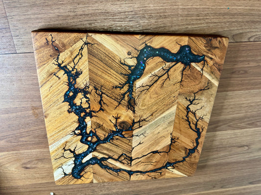 Resin chopping board by Fractal Flow Designs combining bold resin artistry with natural timber. Perfect for charcuterie platters, luxury gifting, and everyday use in gourmet kitchens.