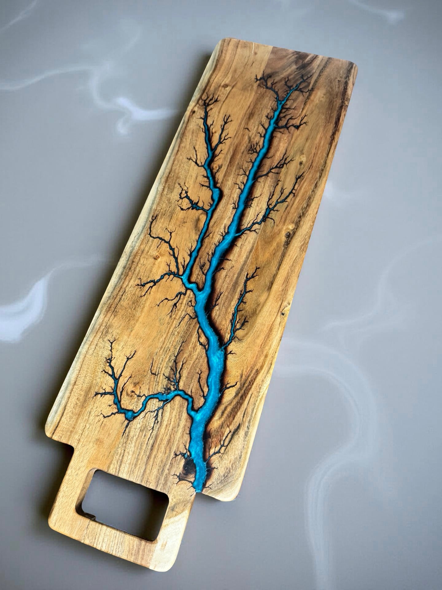 Lagoon blue electric burning art in resin on a long grazing board, handcrafted Australian serving piece