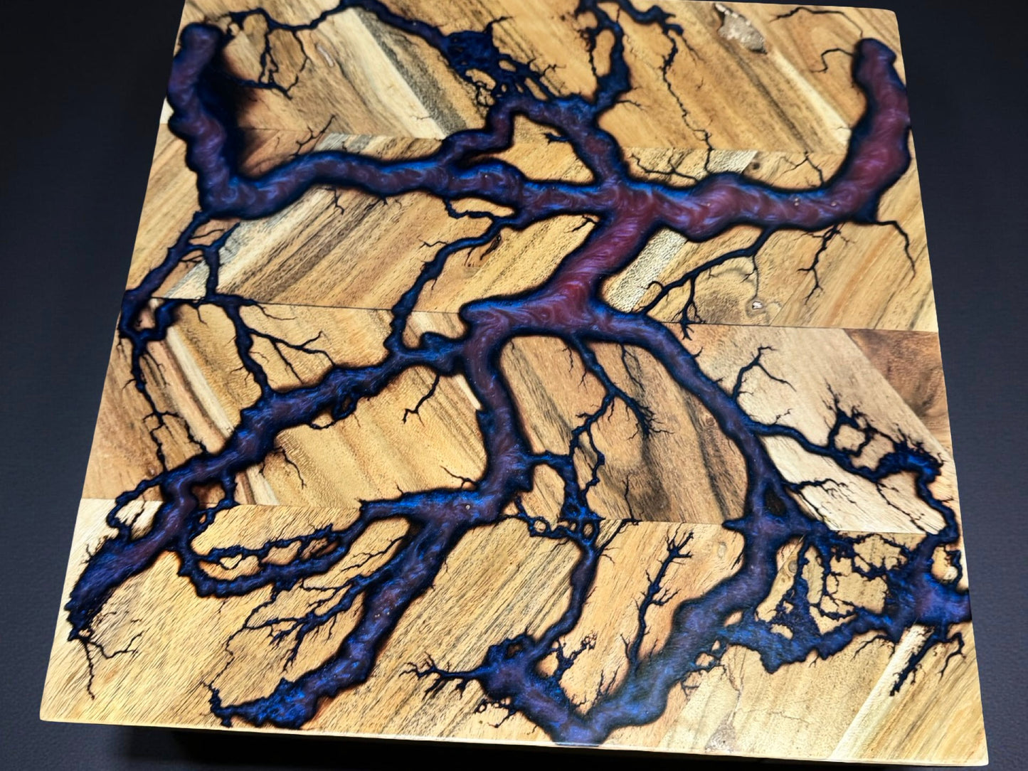 Unique 320 x 320 resin chopping board from Bairnsdale Australia featuring intense red green chameleon pigments and natural fractal burning marks crafted by Fractal Flow Designs Australia’s resin board brand using native Australian timber