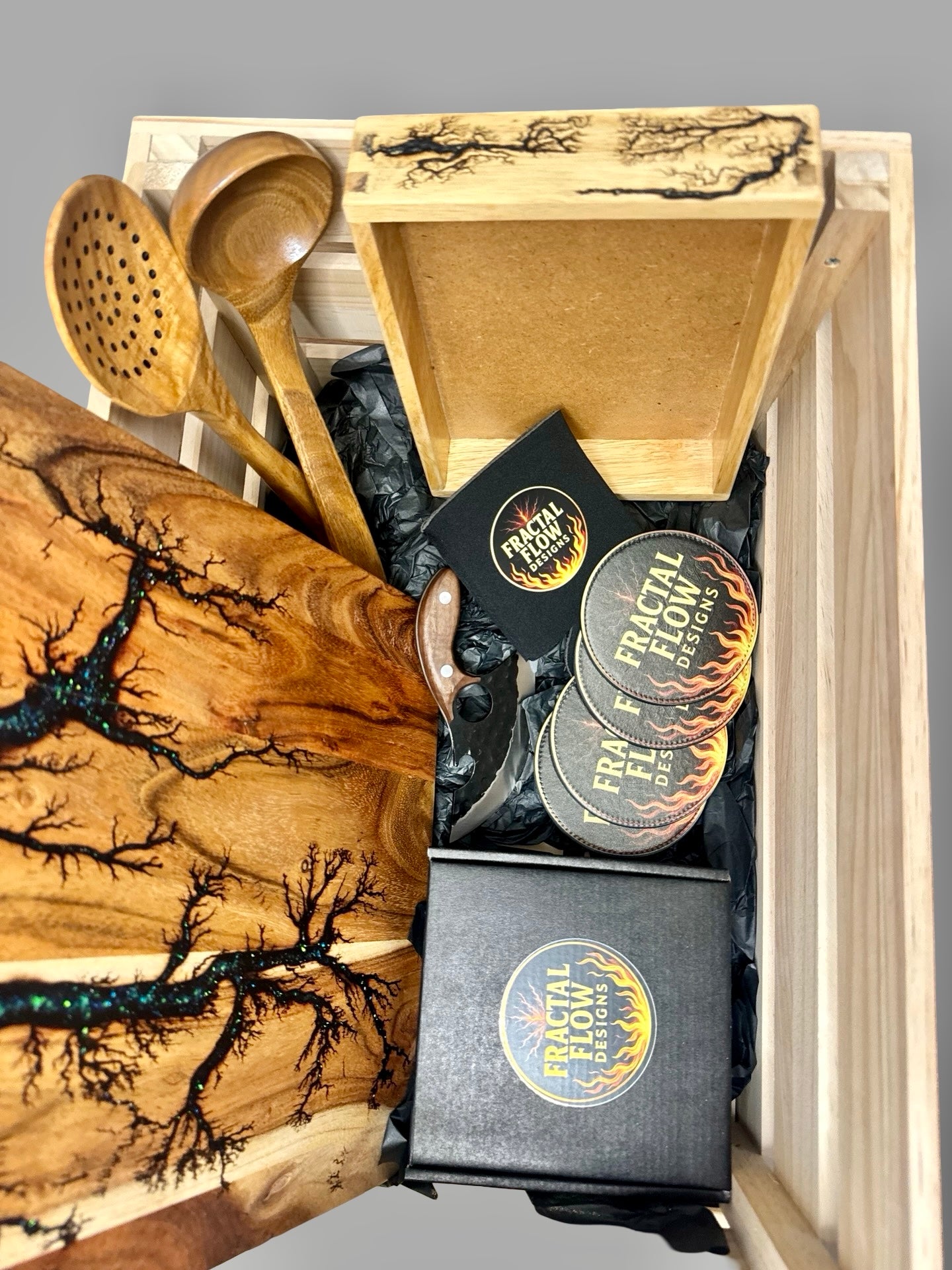 Exclusive resin board premium gift set by Fractal Flow Designs with herringbone charcuterie board, resin paddle, and gourmet extras