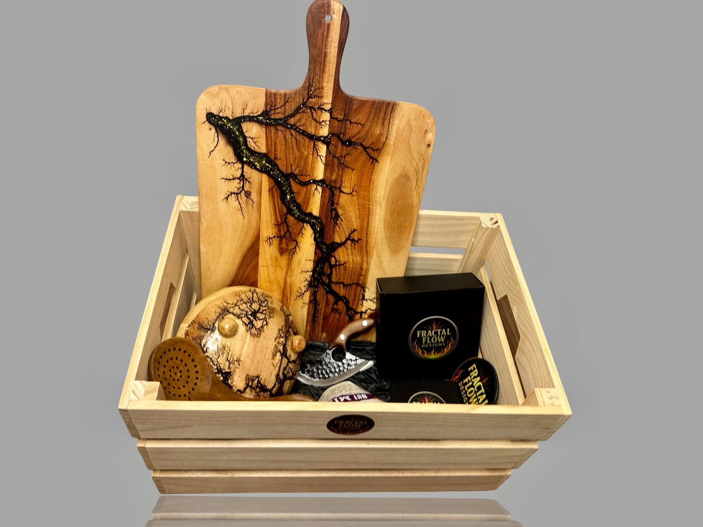 Premium resin board gift box with handcrafted herringbone board, forged cleaver, resin cheese paddle, coasters, and care kit by Fractal Flow Designs