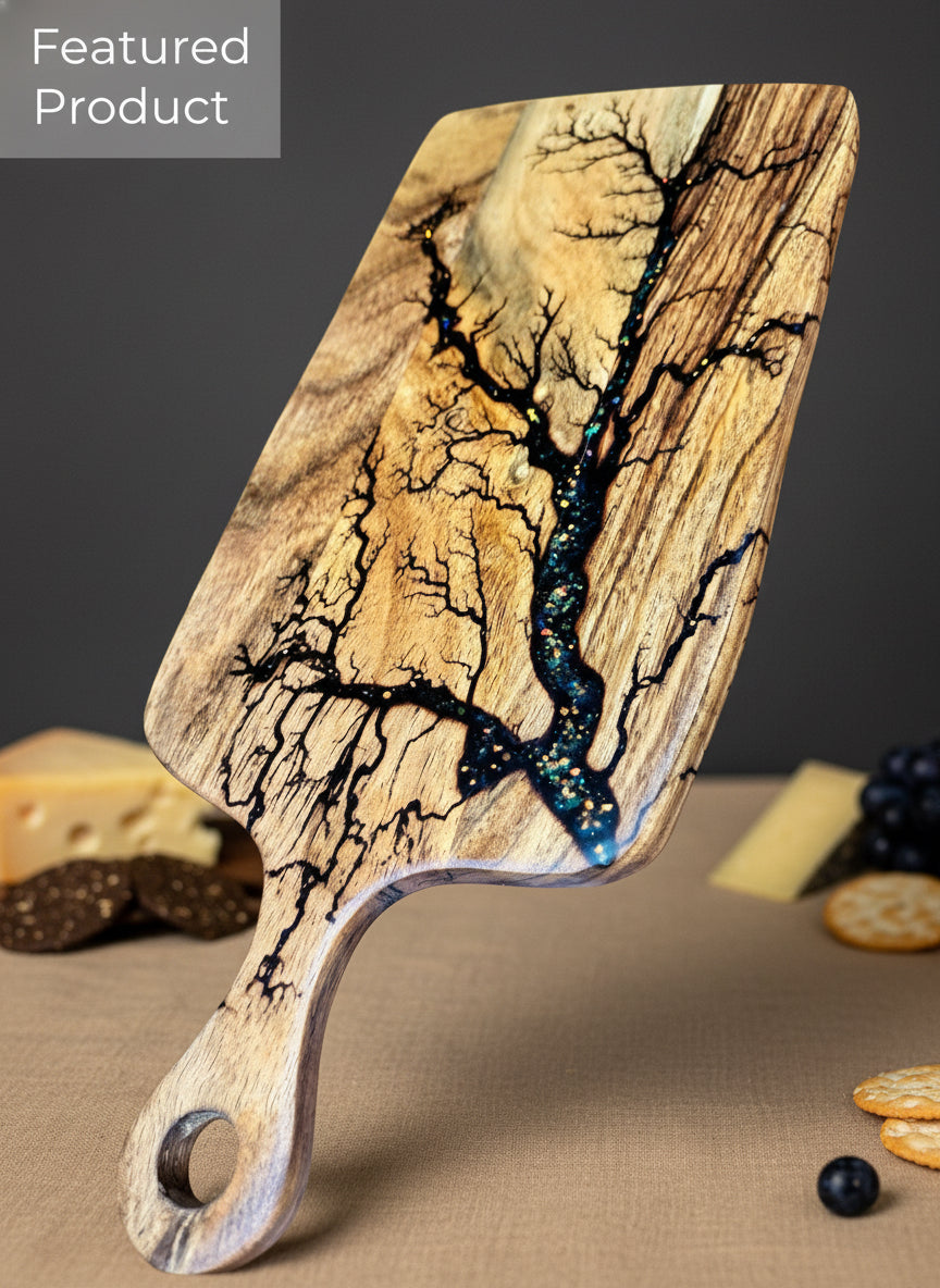 Artisan resin paddle cheese board featuring unique fractal burning detail. Handmade by Fractal Flow Designs in Australia, designed for charcuterie, grazing, and luxury gifting.