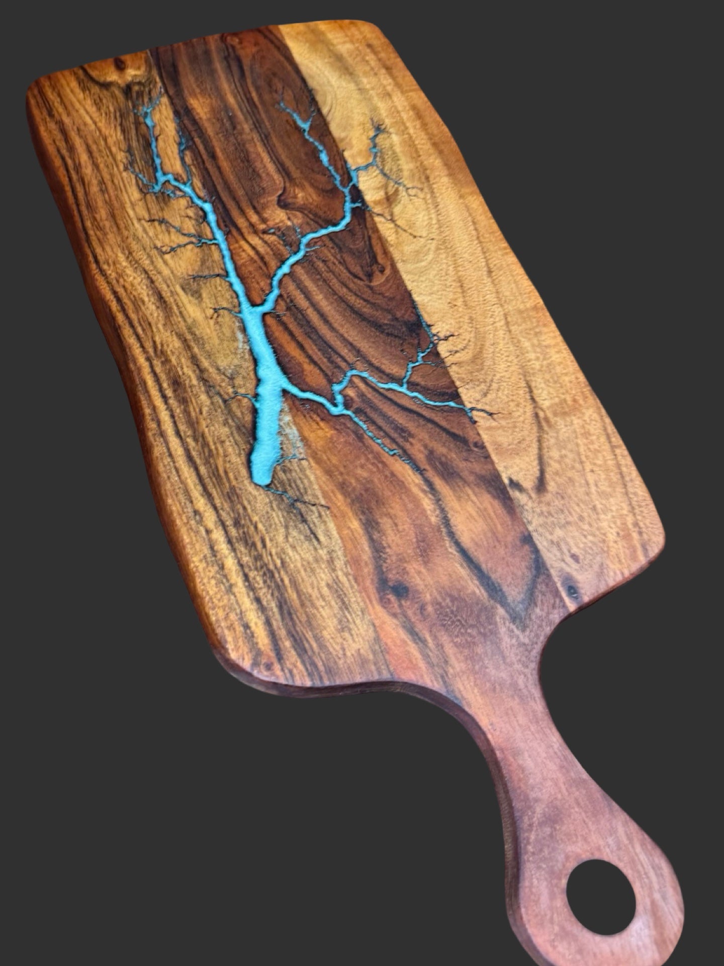 Fractal Flow Designs resin paddle cheese board featuring bold fractal burning and food-safe resin art. A unique serving board gift shipped Australia-wide from Bairnsdale.