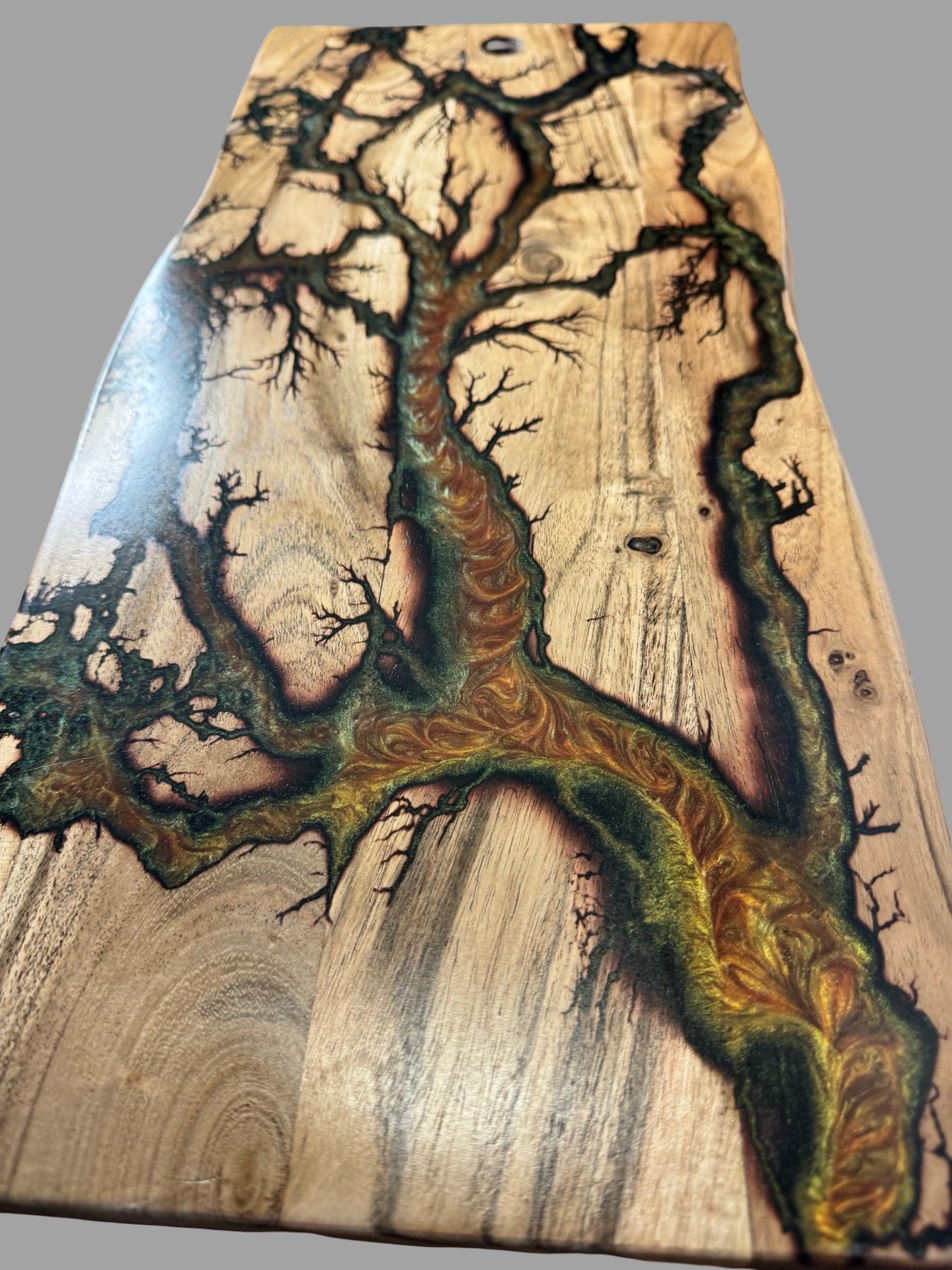 Close up of gold green red chameleon resin detail on live edge charcuterie board fractal burning design by Fractal Flow Designs East Gippsland Australia